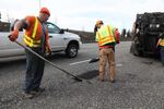 An Oregon Department of Transportation crew fills potholes on Highway 26 in this April 14, 2017, file photo.