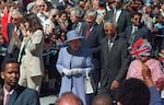 March 20, 1995: Queen Elizabeth II and South African President Nelson Mandela walk from the president's office to parliament in Cape Town, South Africa during the queen's week-long celebratory visit to the country.