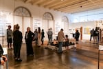 Community members mingle and admire art filling the gallery space at the Center for Native Arts and Cultures during the “Citizen Fellow: Art as Archive and Memory” exhibition opening on Sept. 19, 2024.