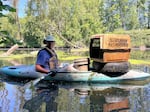 Paul Taylor, pictured on June 22, 2023, has trash piled atop his kayak.