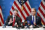 In this photo, Treasury Secretary Scott Bessent and U.S. trade representative Jamieson Greer sit at a table with many microphones on it as they hold a news conference in Geneva on May 12. Both men are wearing suits, and Bessent is on the right side of the frame, while Greer is on the left. American flags are displayed in the background.