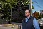 Scotty Kirkland stands in front of a new historical marker in Montgomery, where he is chairman of the Alabama Historical Association's Historical Marker Committee. The committee is trying to move on from Confederate stories through its new History Revealed program.