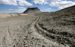 FILE - ATV tracks cross the land leading to Factory Butte on July 12, 2006, northwest of Caineville, Utah. (AP Photo/Douglas C. Pizac, File)