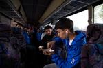 Cesar Gandara eats fries as the McKay boys soccer team boards the bus to Bend.