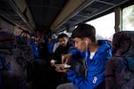 Cesar Gandara eats fries as the McKay boys soccer team boards the bus to Bend.