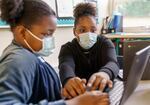 Two students work together on math games in Jasmine Lowe’s combined fourth- and fifth-grade class at Prescott Elementary in Portland. Starting March 12, masks will no longer be required to be worn in public schools and other indoor public spaces in Oregon. 