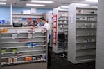 FILE - A pharmacist at the CVS pharmacy at Target in the Tenleytown area of Washington, March 17, 2020. (AP Photo/Carolyn Kaster)