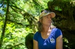 Anna Buckley, the Bull Run Watershed Protection Manager for the Portland Water Bureau, sits in the woods in the Bull Run Watershed on July 16, 2024. 