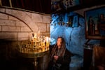 A woman lights a candle in the Tomb of the Virgin in Jerusalem on Palm Sunday, March 24. The war in Gaza deterred many visitors and pilgrims from visiting Jerusalem during Easter. Palestinian Christians in the Israeli-occupied West Bank were among those affected by Israeli restrictions on Palestinian travel into Jerusalem. Men had to be age 55 and older, and women had to be 50 and over.