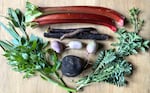 Assorted garden vegetables on a wooden table.