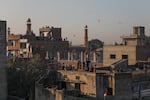 People flying kites stand on rooftops in Lahore's Old City during Basant on Feb. 7, 2026, in Lahore, Pakistan.