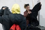 Scout Gilson, harm reduction outreach specialist at Prevention Point, gives out clothing to clients in the Kensington neighborhood of Philadelphia, Pa., on Feb. 28.