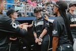 Brittany Apgar (left), Maggie Foxx (center), and Mo'ne Davis (right) of the Los Angeles Queens exchange jokes in the dugout prior to the start of the inaugural game of the Women's Pro Baseball League. Springfield, IL, August 3, 2026.