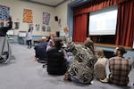 Nichole Watson, center left, senior director of Portland Public Schools' Family & Community Engagement office, speaks with attendees at the start of a community event at Vernon K-8 School in Portland, Ore., on Oct. 29, 2025. The event was one of several to gather feedback on the proposed changes to Jefferson High School's enrollment system.