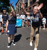 Oregon first lady Aimee Kotek Wilson, left, and Gov. Tina Kotek, right, parade through the streets of downtown Portland.