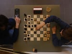 Visitors play chess at The World Chess Club Berlin in Germany on May 9. The German Chess Federation described the new international policies for transgender chess players as discriminatory.