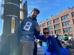 Seattle Seahawks fans Rahul Prasad and Destiny Linayao pause their partying to take a photo during the Super Bowl LX parade on Wednesday, Feb. 11, 2026. Prasad came all the way from Ohio to attend the game in California, then decided to drive to Seattle when the Seahawks won.