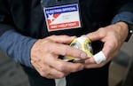 In this file photo, a poll worker rolls up stickers while working inside a FEMA tent used as a voting site on November 5, 2024 in Morganton, North Carolina.