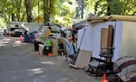 Dozens of people were living in tents, trailers and cars along Southwest Oak Street, next to Portland's Laurelhurst Park, July 26, 2021. The city later cleared the encampment. City and county leaders have agreed to spend $38 million to expand the Portland region’s homeless shelter capacity and increase the number of campsite cleanups and removals.