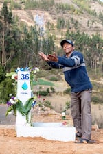 In this 2024 supplied photo, Victor Lopez throws water in the air during a community celebration of having reliable access to clean water in Tolapampa Bajo, Cochabamba, Bolivia. Green Empowerment, a Portland-based nonprofit, helped with the clean water project.