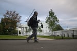 A CNN sound technician walks at the White House, Saturday, Sept. 26, 2026, in Washington.