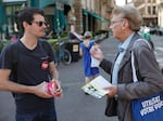A member of the French Communist Party (left) campaigning for the upcoming legislative election talks with a supporter of French President Emmanuel Macron at a market, June 26, in Strasbourg, eastern France. The two-round parliamentary election will take place on June 30 and July 7.