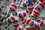 St. Louis County voting stickers are laid out for voters at Holy Name Community Center in Bellefontaine Neighbors, Mo.