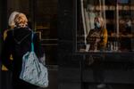 Two women wait in line at a bakery in Antwerp, Belgium, Wednesday, Nov. 4, 2020. Belgium, proportionally still the worst-hit nation in Europe when it comes to coronavirus cases, said Wednesday there increasing signs of that a turning point in the crisis was drawing close. The announcement came in the wake of increased measures over the past weeks with bar and restaurant closures capped by a partial lockdown starting last Monday, which further restricted close contacts and closing non-essential shops.