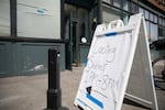 A sign directing people inside the Old Town Cooling Center on Northwest Glisan Street in Portland on Aug. 14, 2023. People seeking cooling were offered water, snacks, towels and hygiene products to maintain self-care in the extreme heat.