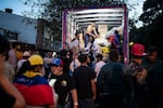 People unload donated supplies from a truck at a collection point in Bogota on June 26, 2026, as humanitarian aid to be sent to Venezuela following deadly earthquakes.