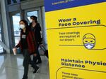 People enter wearing masks at John F. Kennedy Airport on April 19 in New York City. On Monday, a federal judge in Florida struck down the mask mandate for airports and other methods of public transportation as a new COVID variant is on the rise across parts of the United States.