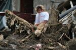 A villager watches rescue operations after a recent landslide triggered by Tropical Storm Trami struck Talisay, Batangas province, Philippines leaving thousands homeless and several villagers dead on Saturday, Oct. 26, 2024.