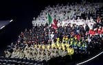 Athletes in Milan finished their Parade of Nations route at rows of seats just offstage.