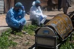 Relatives mourn near a coffin containing the body of a person who died of COVID-19 in Srinagar, Indian controlled Kashmir, Sunday, April 25, 2021. India’s crematoriums and burial grounds are being overwhelmed by the devastating new surge of infections tearing through the populous country with terrifying speed, depleting the supply of life-saving oxygen to critical levels and leaving patients to die while waiting in line to see doctors.