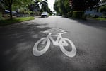 File photo of a bicycle symbol painted on a road. Portlanders are calling for more bike safety in the city after a fatality last week. 