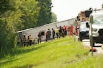First responders work to rescue victims at the scene of a tour bus that crashed and rolled over on the New York State Thruway near Pembroke, N.Y., on Friday.
