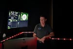 Software Engineer Jonathan Zahn looks at the Orion Engineering Simulator screens inside the Beta Dome.