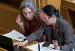 FILE - Rep. Maxine Dexter, D-District 33, left, confers with Rep. Thuy Tran, D-District 45, while in session at the Oregon State Capitol in Salem, March 20, 2023.