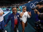 Silver medalist Simone Biles (L) and bronze medalist Jordan Chiles (R) of Team United States celebrate after competing in the floor exercise final last week. Chiles had just learned she was moved from fifth to third following a scoring inquiry. An independent court arbitrator has determined that inquiry was made four seconds to late.