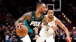 Portland Trail Blazers guard Damian Lillard, left, drives to the basket against New Orleans Pelicans guard CJ McCollum during the first half of an NBA basketball game in Portland, Ore., Wednesday, March 1, 2023.