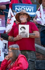 Vice Chairman of the Chinook Indian Nation Sam Robinson, holds photographs of his relatives, including aunt Lois Gardner, while gathered on the steps of the Henry M. Jackson Federal building during a rally for the restoration of federal recognition for the Chinook Indian Nation, on Monday, August 29, 2022, in Seattle.