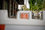 A sign promoting safe shopping habits sits outside of the Woodstock location of New Seasons Market in Portland, Ore., on Wednesday, April 29, 2020.