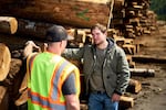 Alek Skarlatos, right, speaks with a Douglas County woodworker during a campaign stop on Feb. 6, 2020.