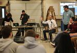 Think Out Loud host Dave Miller talks to high school students in an Oregon City High School shop class, encouraging them to participate in the show about to begin.