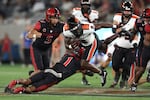 Oregon State running back Jam Griffin (8) is tackled by San Diego State cornerback Chris Johnson (1) by during the first half of an NCAA college football game Saturday, Sept. 7, 2024, in San Diego. (AP Photo/Raul Romero Jr.)