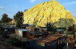 Shacks built below a gold mine dump in the Jerusalem squatter settlement, east of Johannesburg, South Africa, on Oct. 28, 2014. The squatter camp is established on the fringes of the skyscrapers of Johannesburg "The City of Gold" on gold mine dumps bearing testimony to the crumbling dreams of millions for a better life after apartheid's end.