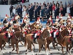 President Donald Trump, first lady Melania Trump, French President Emmanuel Macron, centre, and his wife Brigitte Macron look out from the viewing stand during Bastille Day parade on the Champs Elysees avenue in Paris on July 14, 2017.