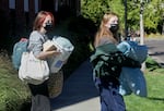 Zoë Diskin, left, gets help from her younger sister Clare, to move into the dorms in Corvallis, Ore., at Oregon State University on Sept. 20, 2021.