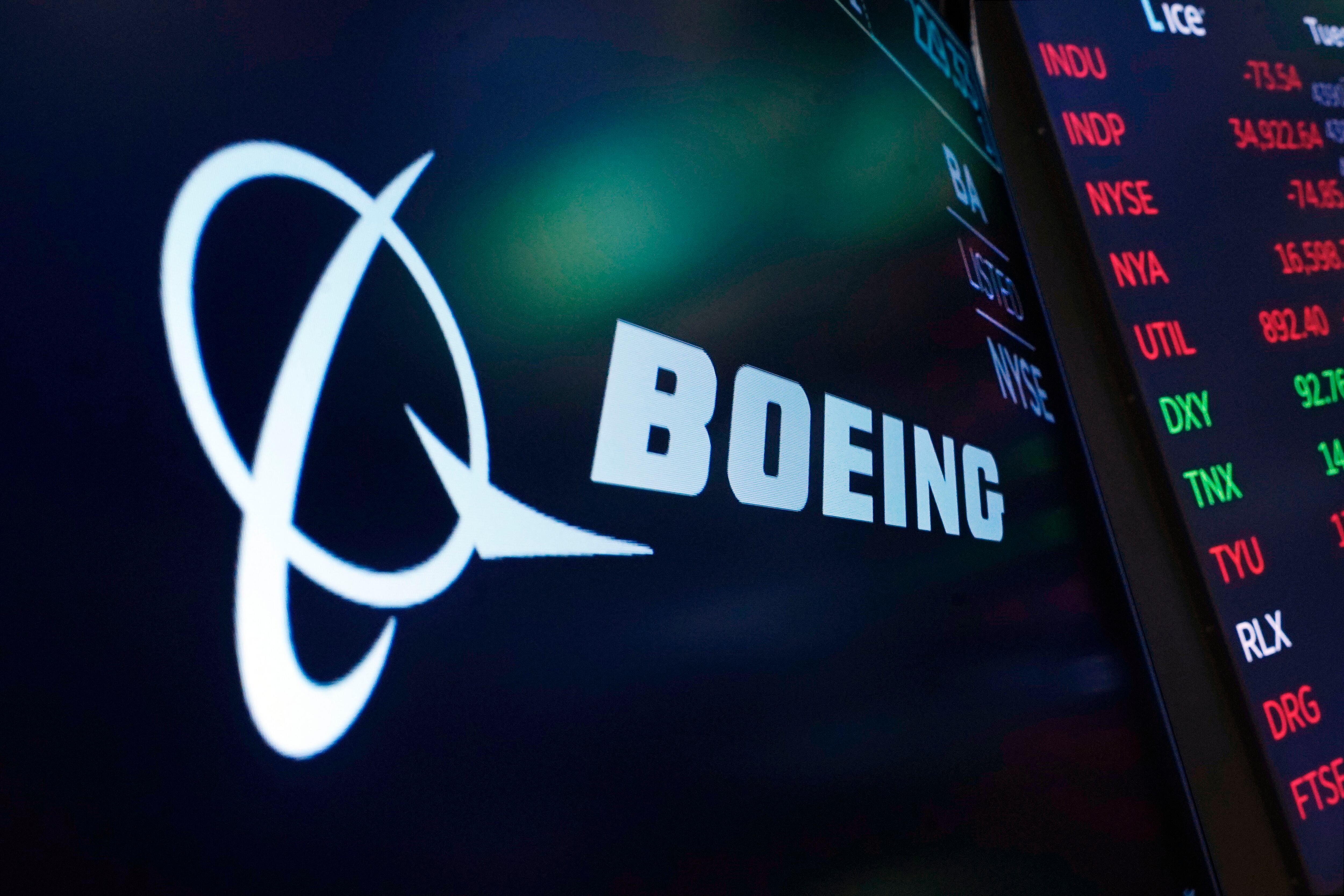 FILE - The logo for Boeing appears on a screen above a trading post on the floor of the New York Stock Exchange, Tuesday, July 13, 2021. Boeing has locked out its private force of firefighters who protect its aircraft-manufacturing plants in the Seattle area, Saturday, May 4, 2024, and brought in replacements after the latest round of negotiations with the firefighters' union failed to deliver an agreement on wages.