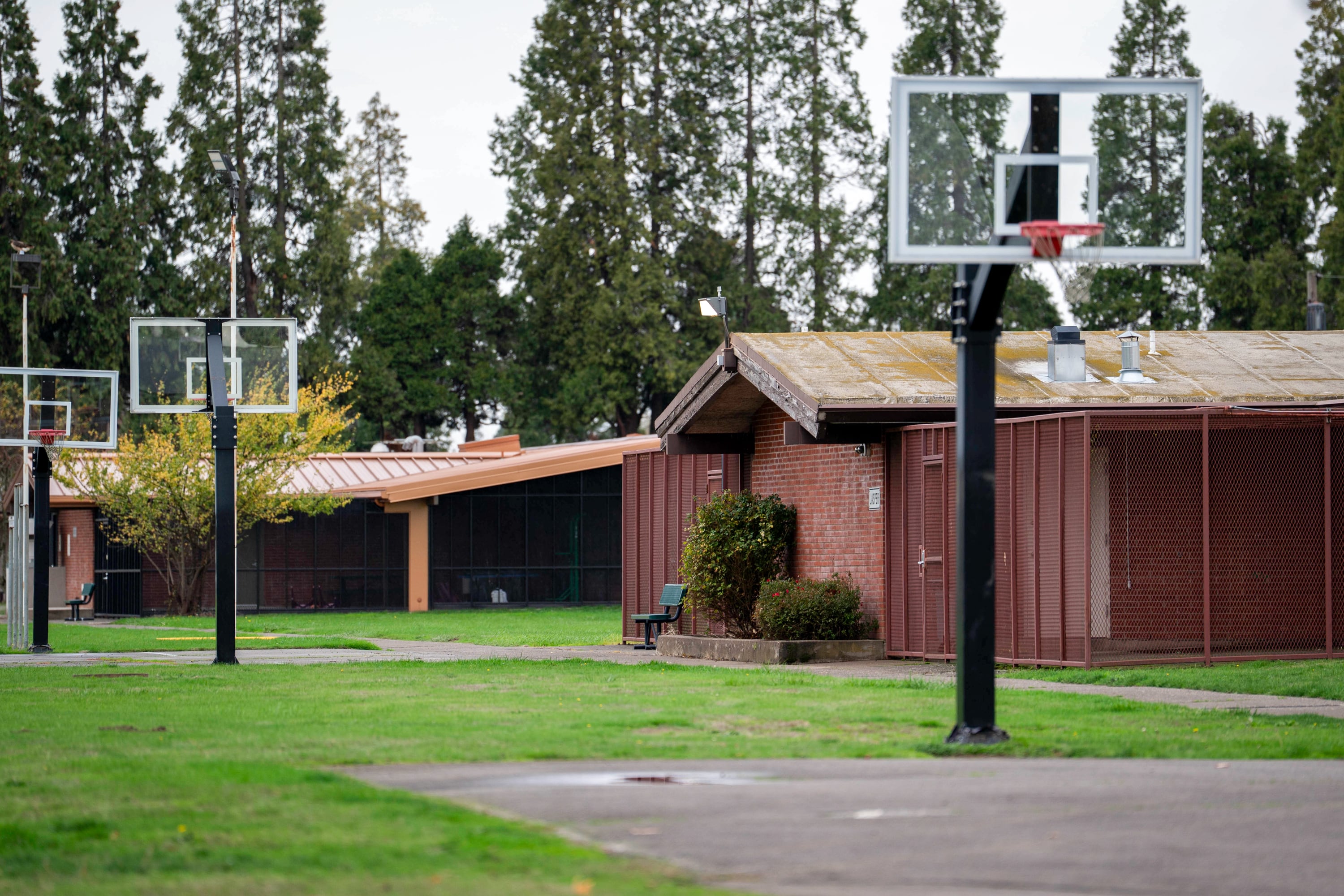 Basketball courts stand outside of detainee residences at MacLaren Youth Correctional facility in Woodburn, Ore., on Nov. 6, 2025.